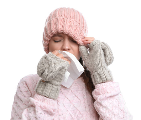 Young woman suffering from cold on white backgroundの写真素材