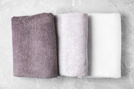 Fresh towels on gray marble table, top viewの写真素材
