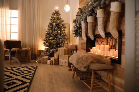 Stylish room interior with beautiful Christmas tree and decorative fireplaceの写真素材