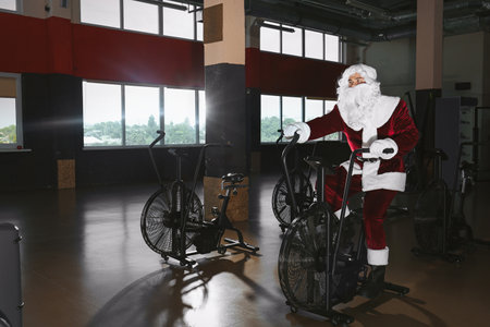 Young Santa Claus training in modern gymの写真素材