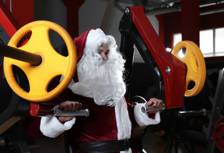 Young Santa Claus training in modern gymの写真素材