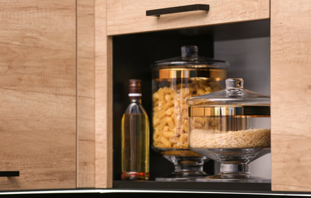 Shelf with raw cereals in modern kitchenの写真素材