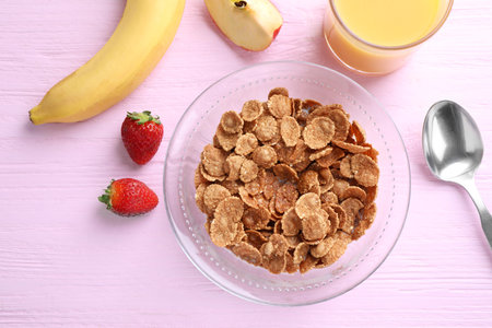 Flat lay composition with cornflakes on pink wooden table. healthy breakfastの写真素材
