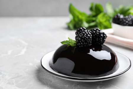 Delicious jelly with blackberries and mint on gray tableの写真素材