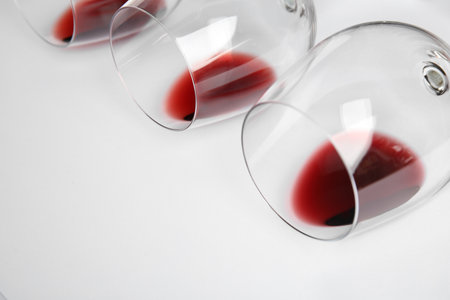 Transparent glasses with exquisite red wine on white background, closeupの写真素材