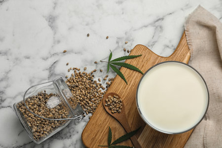Flat lay composition with glass of hemp milk on marble tableの写真素材