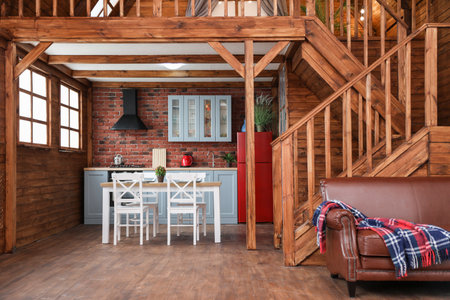 Stylish house interior with dining table, chairs and sofaの写真素材