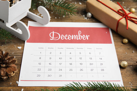 Paper calendar and festive decor on wooden tableの写真素材