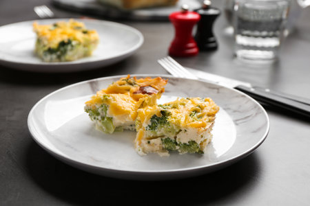 Pieces of tasty broccoli casserole on gray tableの写真素材