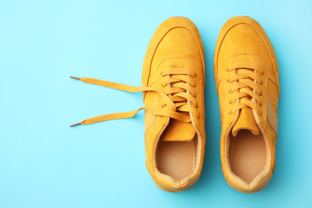 Pair of stylish shoes on light blue background, top view. Space for textの写真素材