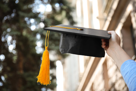 Student with graduation hat outdoors on sunny day, closeupの写真素材