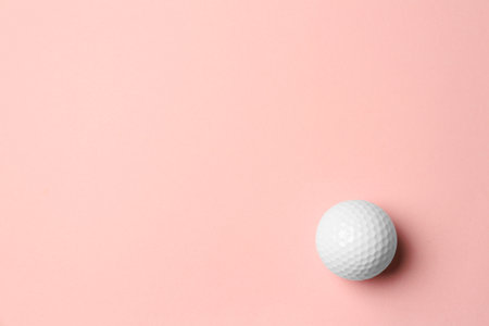 Golf ball on pink background, top view. Space for textの写真素材