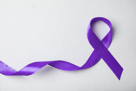 Purple ribbon on gray background, top view. domestic violence awarenessの写真素材