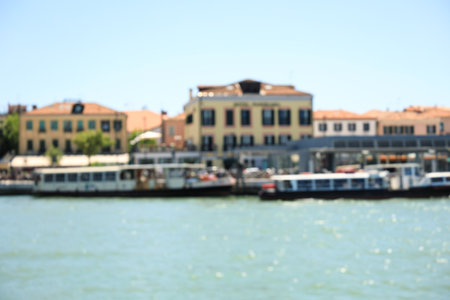 VENICE, ITALY - JUNE 13, 2019: Blurred view of city on sea shoreの写真素材