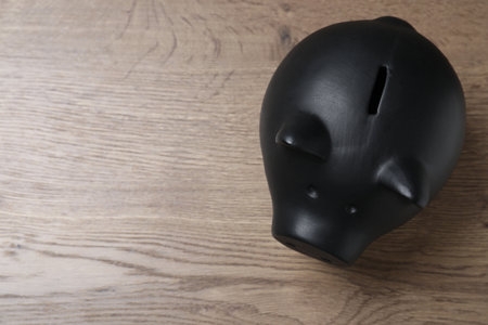 Piggy bank at wooden table, top view with space for text. money savingsの写真素材