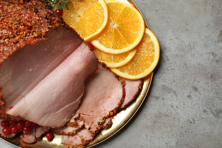 Delicious ham served for Christmas dinner on gray table, top viewの写真素材