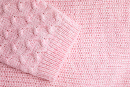 Pink knitted sweater as background, closeup viewの写真素材