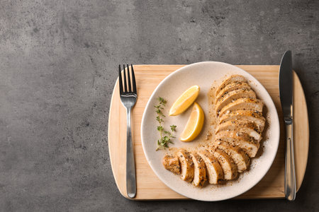Tasty fresh lemon chicken served on gray table, top view.Space for textの写真素材