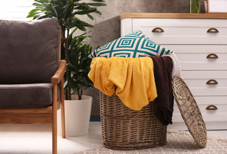 Basket with blankets and pillow near in roomの写真素材