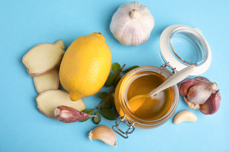 Flat lay composition with garlic and other cold remedies on blue backgroundの写真素材