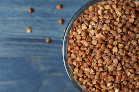 Buckwheat grains on blue wooden table, top view. Space for textの写真素材