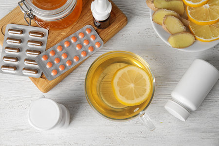 Flat lay composition with different cold remedies on white wooden tableの写真素材