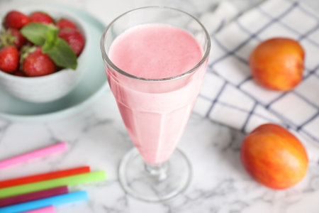 Tasty milk shake on white marble tableの写真素材