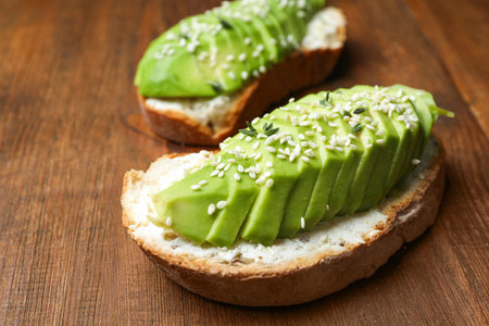 Tasty sandwich with avocado on wooden table, closeupの写真素材
