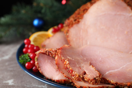 Plate with Christmas ham on gray table, closeupの写真素材