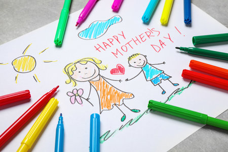 Handmade greeting card for Mother's Day and felt tip pens on gray table, closeupの写真素材