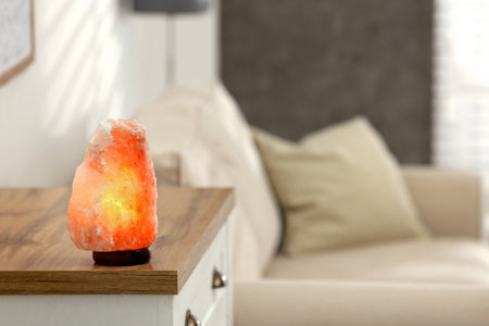 Himalayan salt lamp on table at home, space for textの写真素材