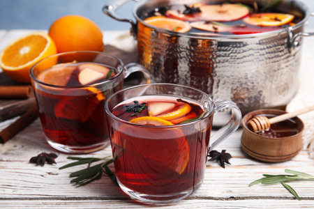Tasty mulled wine with spices on white wooden tableの写真素材
