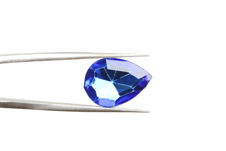 Tweezers with beautiful gemstone on white backgroundの写真素材
