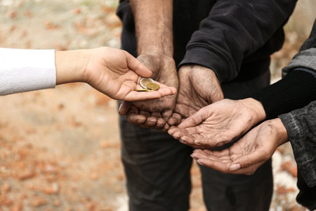 Woman giving poor homeless people money outdoors, closeupの写真素材