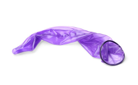 Purple used condom on white background. Safe sex conceptの写真素材
