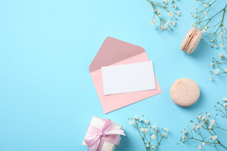 Flat lay composition with greeting card on light blue background, space for text. Happy Mother's Dayの写真素材