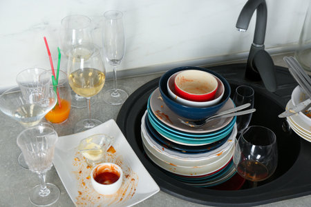 Pile of dirty dishes in the kitchen after partyの写真素材