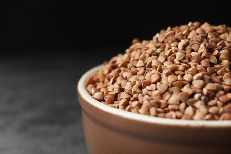 Uncooked buckwheat grains on gray table, closeupの写真素材