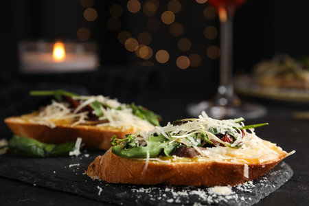 Delicious bruschettas with beef and cheese on black table, closeupの写真素材