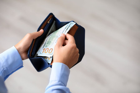 Woman with American money in wallet, closeupの写真素材