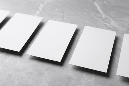 Empty sheets on gray marble table. Mock up designの写真素材