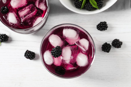 Delicious blackberry lemonade on white wooden table, top viewの写真素材