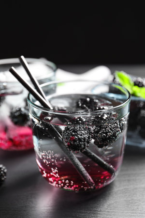 Delicious refreshing blackberry lemonade on dark wooden tableの写真素材