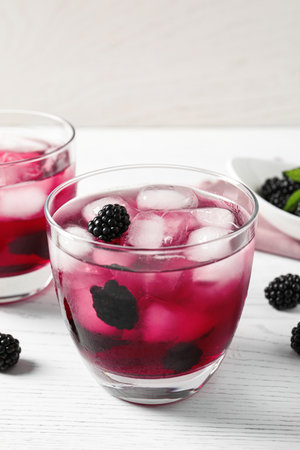 Delicious refreshing blackberry lemonade on white wooden tableの写真素材
