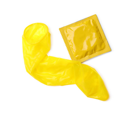 Yellow condoms on white background, top view. safe sex conceptの写真素材