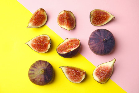 Tasty fresh fig fruits on color background, flat layの写真素材