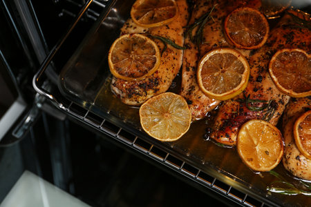 Baking dish with delicious lemon chicken in oven, closeup viewの写真素材