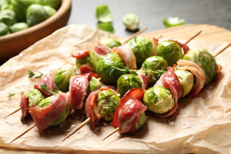 Skewers with delicious Brussels sprouts and bacon on tableの写真素材