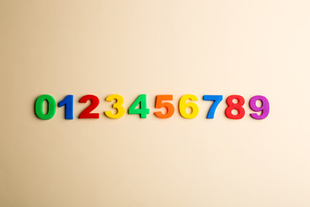 Colorful magnetic numbers on beige background, flat layの写真素材