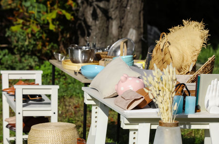 Small tables with many different items on garage sale outdoorsの写真素材